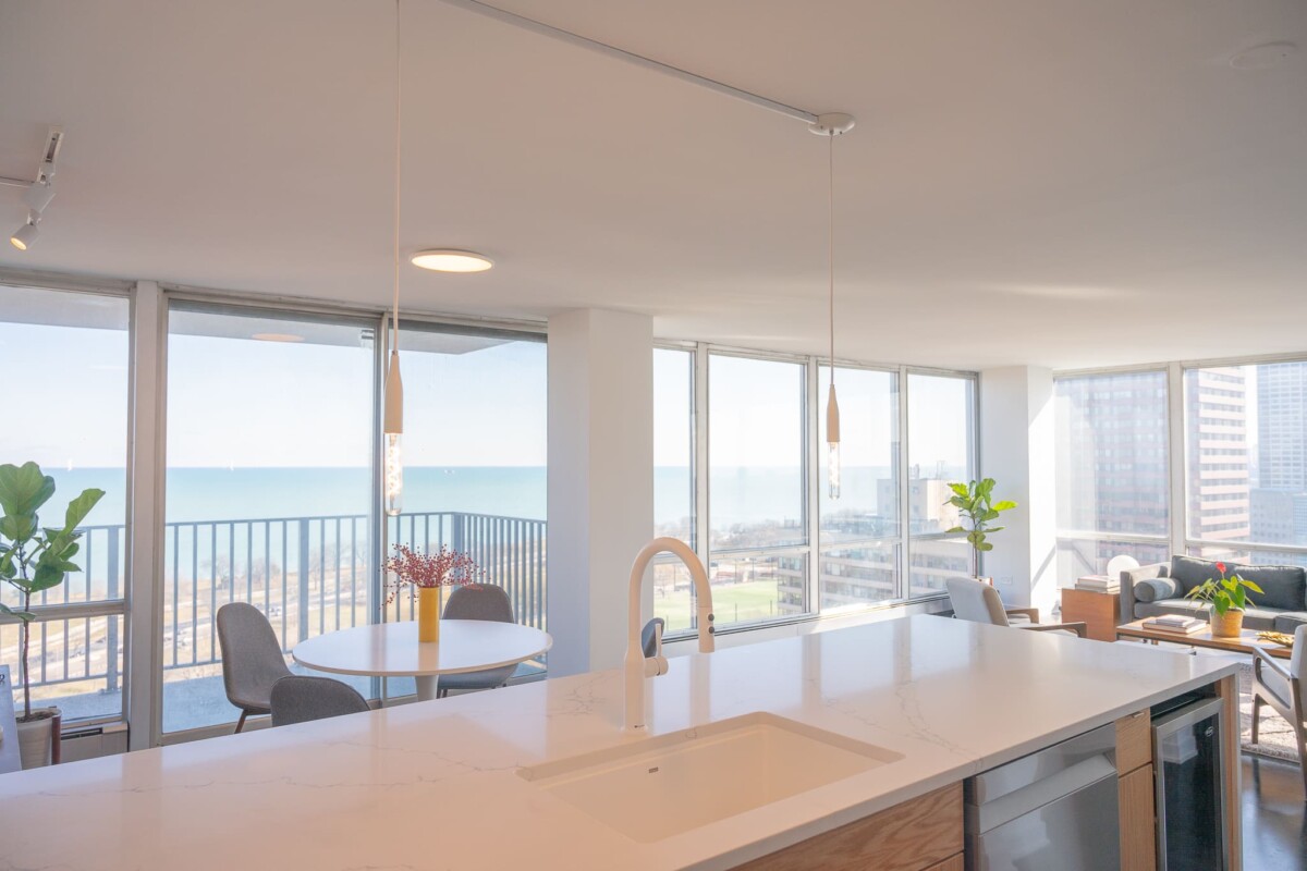 Interior design hero image for About Us page featuring bright, open-plan kitchen and living space.